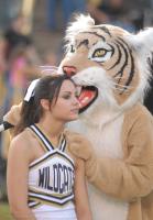 The Blacksburg High mascot looks like he is taking a bite out cheerleader Kaila Burton's head  but is just talking to her at the game with Friday night with Chapman High School at Blacksburg Sat. night Sept., 9 2006. Chapman won the game 38 to 16.(STAND ALONE)
