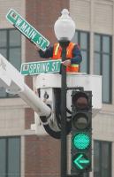 Larry Richards with the City Of Spartanburg engineering Department puts up signs for W. main and Spring Street early Tuesday Morning, May 9, 2006. The crew will be putting up other signs downtown.