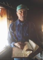 James W. Jeter stand in whats left of his Pacolet Mills home and shows the Bible that was damaged from fire and water during a recent fire. The bible they kepy next to their bed was completly destroyed. The Jeter's lost all their belongings and their home was destroyed. The Spartanburg Sheriffs Department donated a new Bible and clothing to the family along with cash and the promise of a new home.