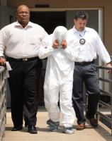 Deputies have made an arrest in an early morning homicide that was reported after an SUV stopped in downtown Spartanburg with the victim’s body inside, Monday, July 21. Here Dimitrius Glenn and Lorin Williams with the Spartanburg County Sheriff's Office escort Manuel Antonio Marin-Arredondo to a  car to trasport him to the Jail.
