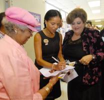 Actress Victoria Rowell signs autographs for fans,  Barbara Fielver (L) and Joanne Fogle (R), before speaking at CC Woodson, during a two-day tour of S.C. supporting Presidential hopeful Hillary Clinton, Saturday morning,  August 25, 2007, in Spartanburg.