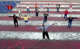 Art Teacher Jimi Ervin and his advanced art class at Granard Middle School in Gaffney S.C. show off their 40' x 70' flag Wednesday October 24, that they and other art students painted using their hands and feet on the schools parking lot. The art classes did the project over a period of time since the September 11 attacks on New York and Washington.