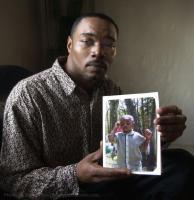 Gregory Ferguson holds a photo of his son Gregory Junior. Ferguson has been facing a charge of assaulting his infant son more than five years ago. It's one of the oldest pending cases in the state.