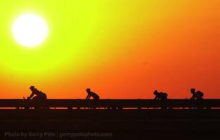 Some of the leading pack of riders in the Assault on Mount Mitchell cross over I-85 on Hwy 9 as the sun rises early Saturday morning.