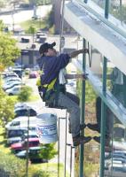 Delfino Rodrigez with Clear-Day Inc. out of Greensboro N.C. washes the windows at the Spartanburg Regional Medical Center in Spartanburg S.C. Friday October 19.